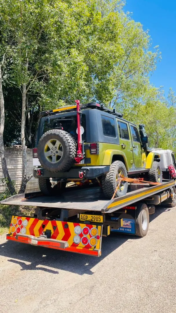 Four-wheel-drive vehicle secured on a Billy Towing flatbed