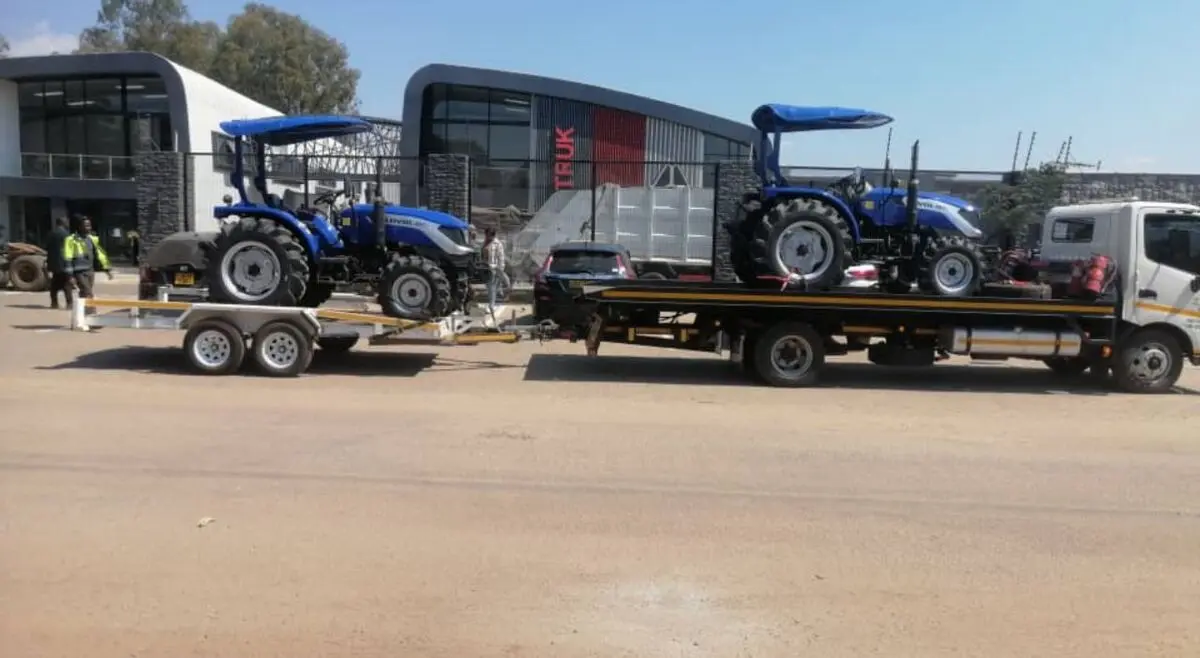 Billy Towing transporting tractors on a flatbed